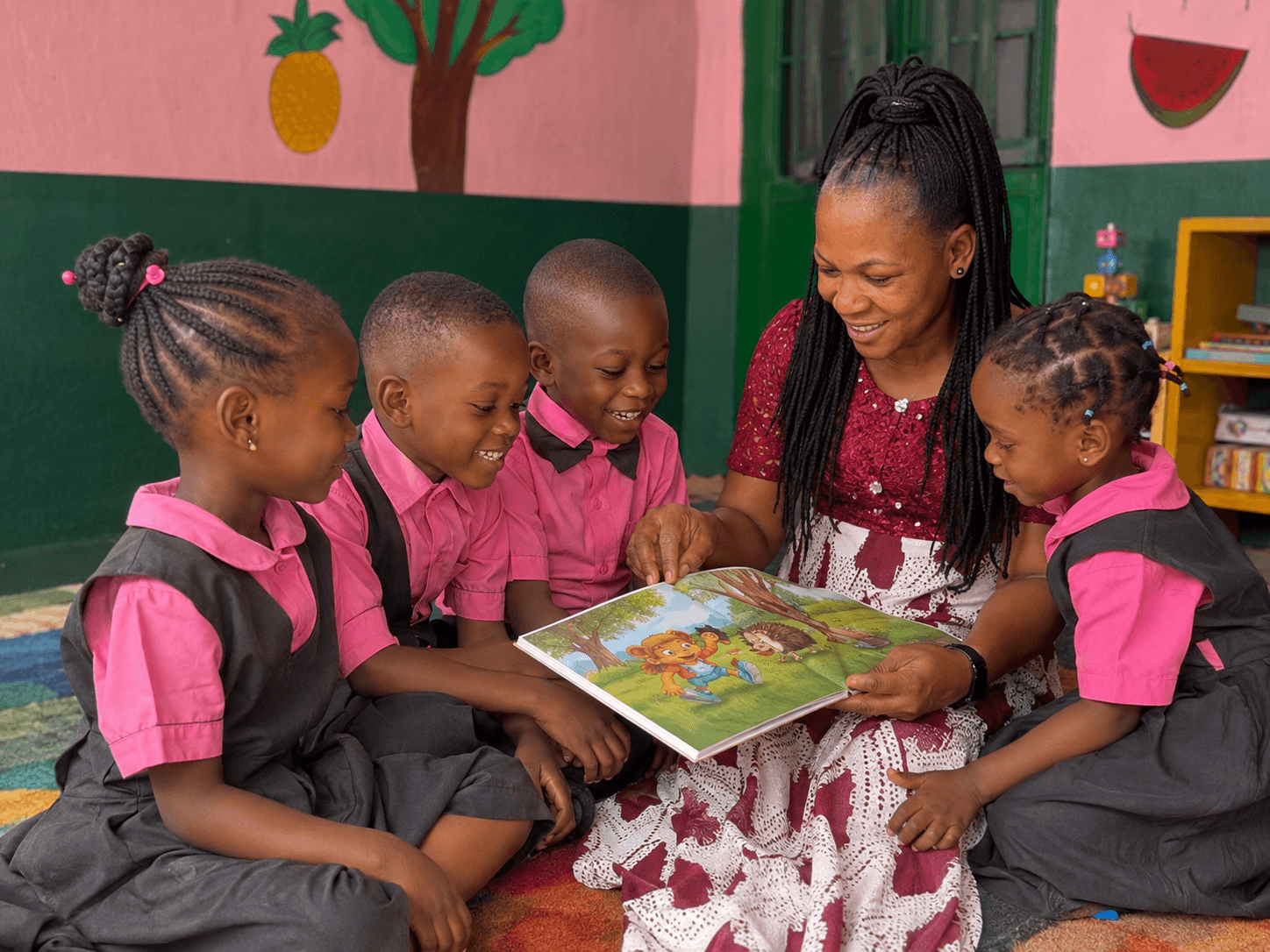A teacher reading a storybook to a circle of young Calvary nursery students