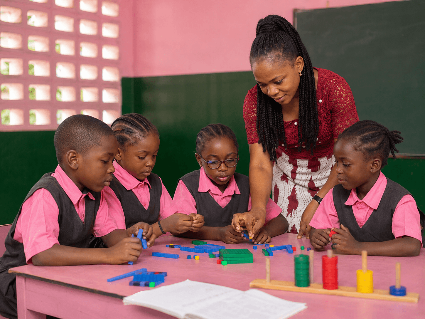 A teacher guiding Calvary primary students through hands-on numeracy with counting manipulatives